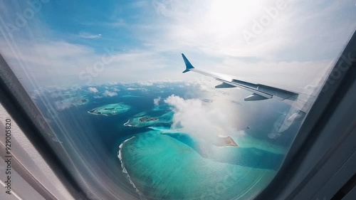 Airplane flies over the islands in the Maldives