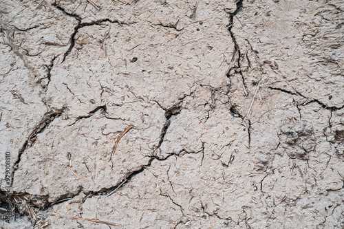 Old cracked wall made of orange clay and straw.