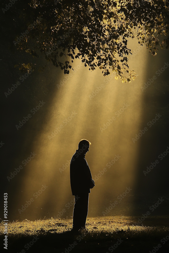 A grateful man prays to God in the serene light of the morning