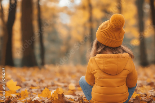 Child Sitting In Autumn Leaves