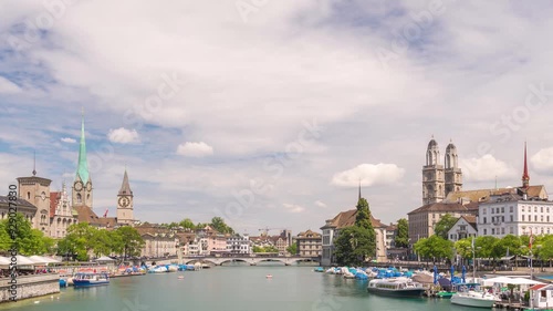 Zurich Switzerland time lapse city skyline at Limmat River with Grossmunster and Fraumunster Church photo