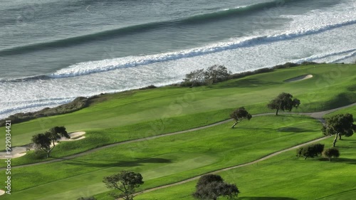 Aerial view of Torrey Pines Golf course on a partly cloudy day in La Jolla San Diego California with views of the Pacific Ocean and Blacks Beach along the cliffs and hills photo