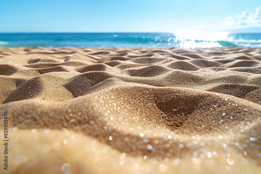 Close-up view of shimmering sand patterns near the ocean, capturing the tranquil essence of a beach under a bright sun. Close-up view of shimmering sand patterns near the ocean, capturing the tranquil essence of a beach under a bright sun.