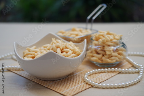 telur gabus sticks in bowl and jar on wooden table background. photo