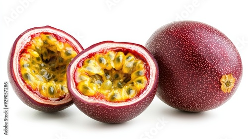 A ripe passion fruit, whole and halved to reveal its bright yellow seeds, isolated on a white background