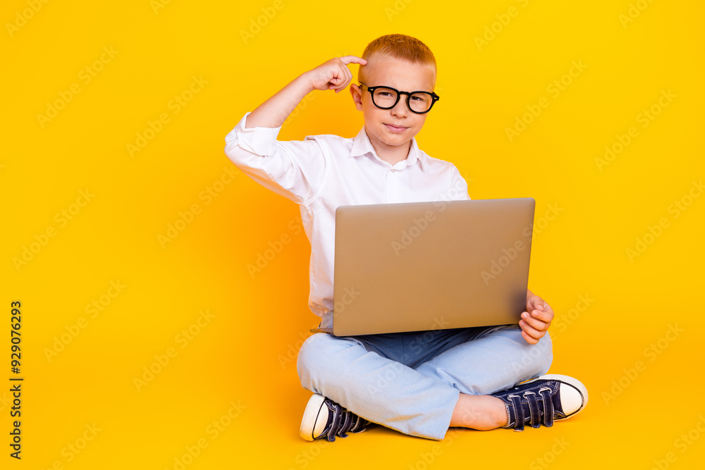 Photo of clever intelligent boy wear white shirt sit floor touch head decision isolated on yellow color background Photo of clever intelligent boy wear white shirt sit floor touch head decision isolated on yellow color background