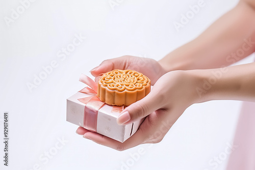 Close up of Asian woman holding mooncake placing on gift box during mid autumn full moon festival photo