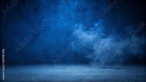 An empty studio room with a dark blue cement wall, smoke rising and creating a textured backdrop for product displays