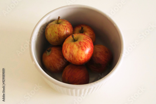 A small white plate with organic, fresh and sweet red apples