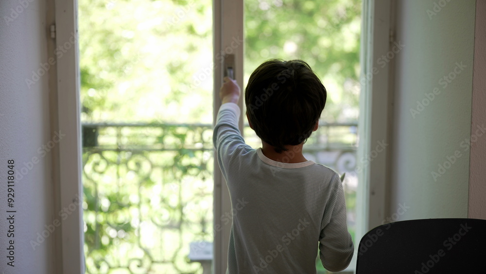 Young boy reaching for the window knob, stepping out onto the balcony to explore, and returning home to close the window. curiosity and interaction with the outdoor environment Young boy reaching for the window knob, stepping out onto the balcony to explore, and returning home to close the window. curiosity and interaction with the outdoor environment