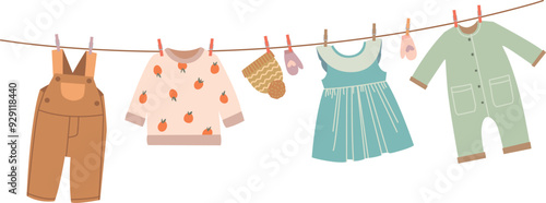 Baby clothes hanging on rope. Kid apparel drying