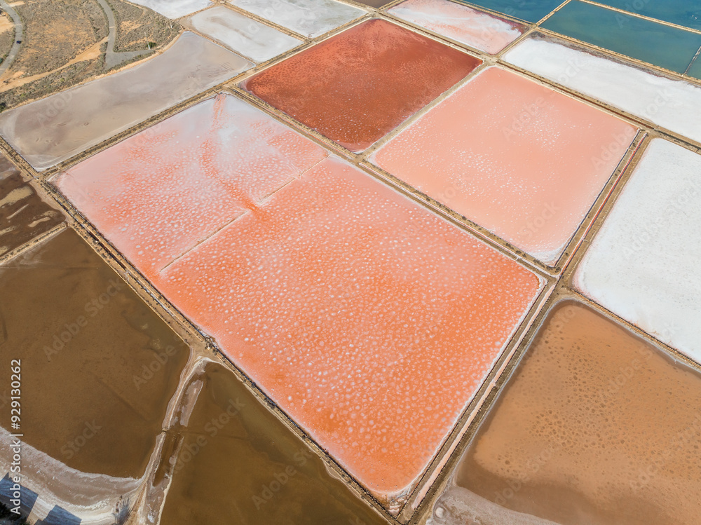Fototapeta premium Aerial view of La Manga salt mines, salt table, with vivid orange, red, pink colors palette ready for a painter to paint
