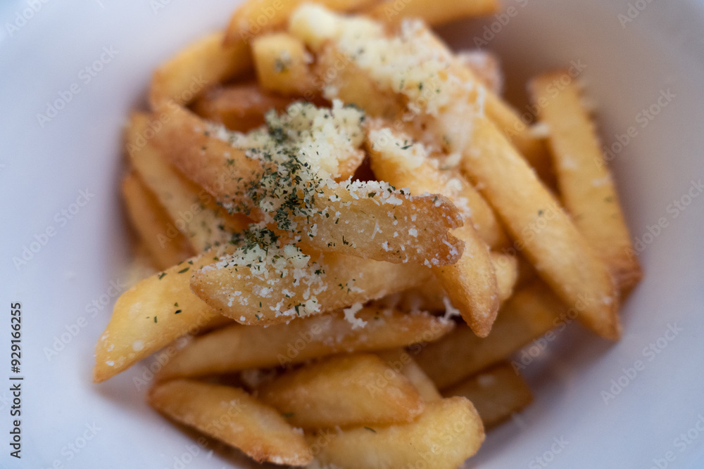 Close-up of French fries with a sprinkling of seasoning that looks delicious. Crispy French fries Close-up of French fries with a sprinkling of seasoning that looks delicious. Crispy French fries