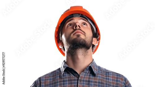 A man s wearing an orange hard hat and a plaid shirt looking up  photo