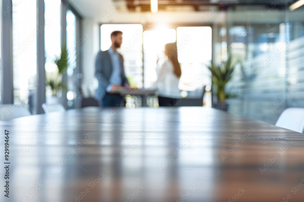 Blurred image of a modern office meeting room with two business professionals in the background, capturing the essence of a contemporary workplace Blurred image of a modern office meeting room with two business professionals in the background, capturing the essence of a contemporary workplace