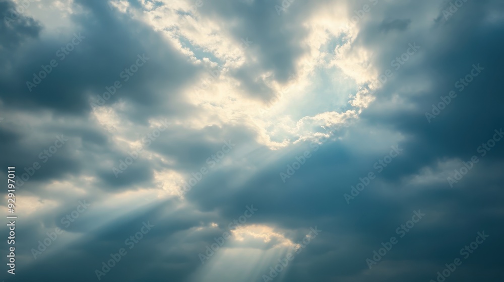 Fototapeta premium A dramatic sky with clouds and rays of sunlight breaking through.