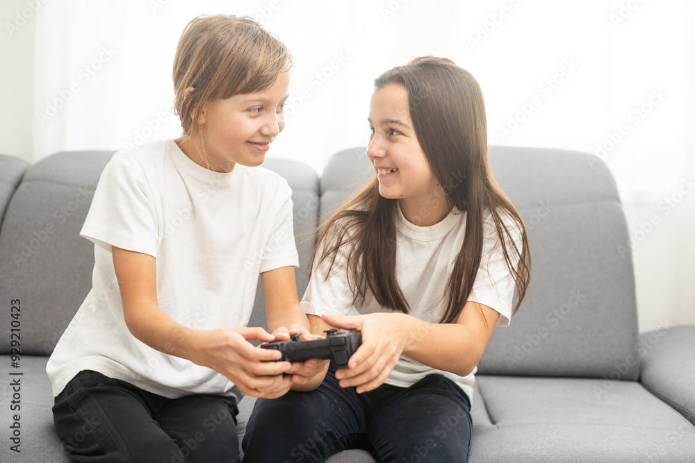 Two middle school girls at home playing an exciting video game together. Two middle school girls at home playing an exciting video game together.