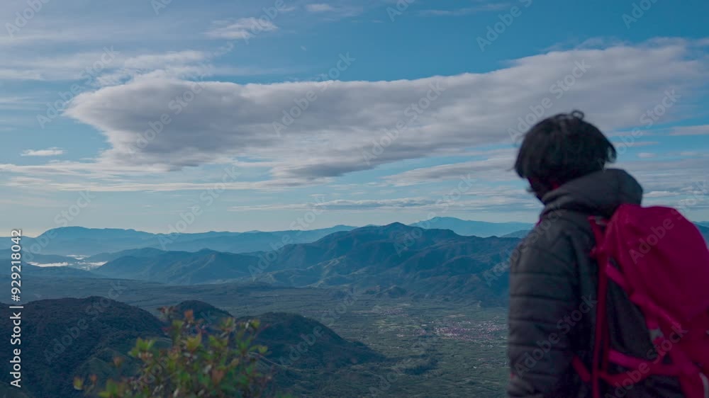 Hiker standing on top of a mountain Hiker standing on top of a mountain