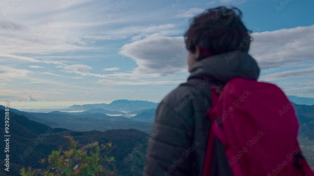 Hiker standing on top of a mountain Hiker standing on top of a mountain