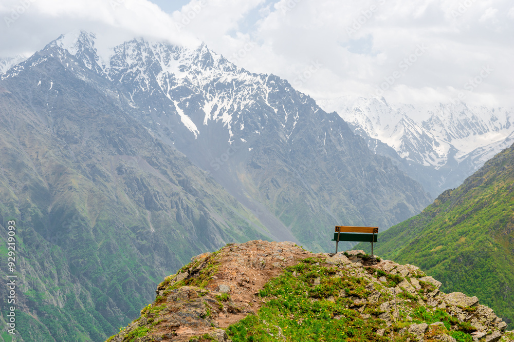 A wooden bench in the mountains overlooking the beautiful picturesque mountains of the North Caucasus. Russia