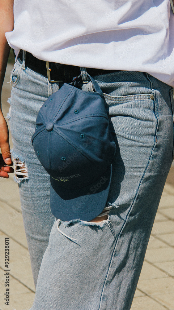 Close-up of a woman holding a blue cap with