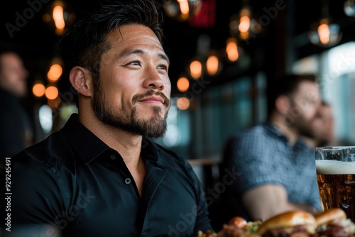 man enjoying a drink and meal at a bar