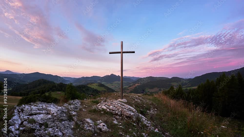 Christian cross on a rock in a mountain landscape, Dramatic clouds over the mountains Christian cross on a rock in a mountain landscape, Dramatic clouds over the mountains