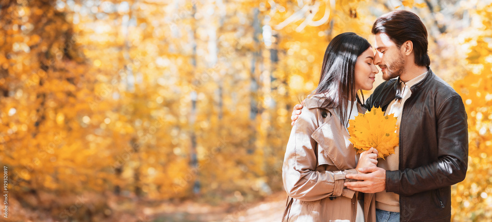 Man and woman full of feelings with closed eyes touching each other while having date at golden forest, copy space Man and woman full of feelings with closed eyes touching each other while having date at golden forest, copy space