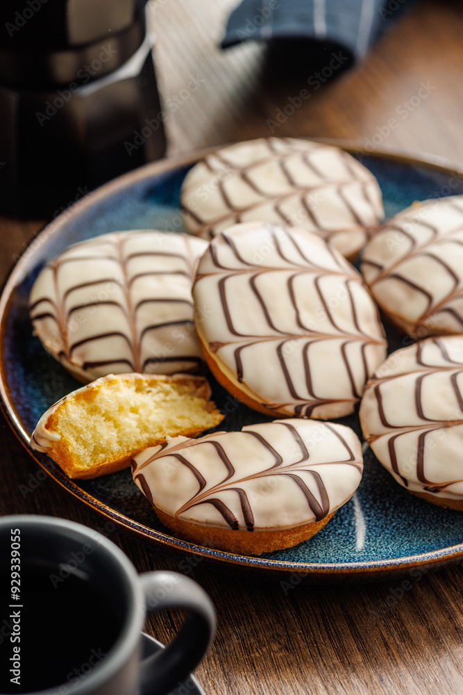 Sweet dessert with sugar coating on plate on wooden table. Sweet dessert with sugar coating on plate on wooden table.