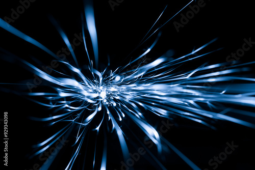 blue sparks from the grinder glowing in the dark