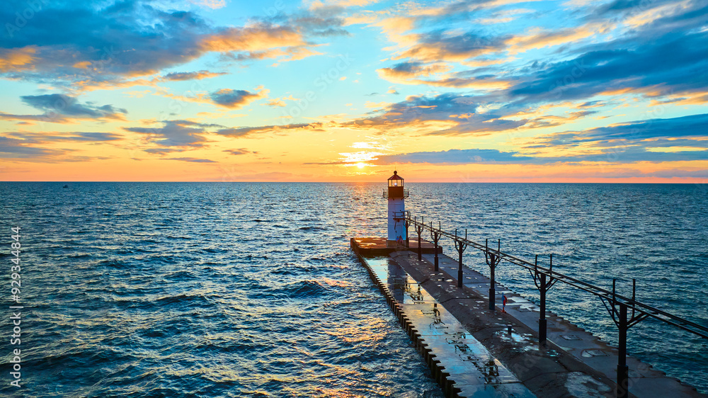Obraz premium Aerial Fly Over Lighthouse and Pier at Sunset, Lake Michigan