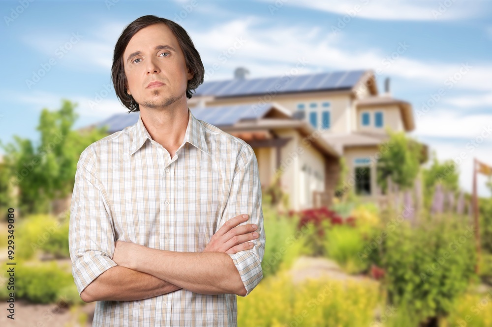 Happy mature modern villa owner standing outside home Happy mature modern villa owner standing outside home