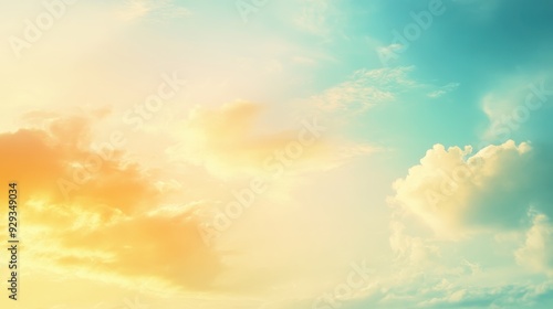 A serene sky at dawn with soft clouds and a gradient of warm and cool colors.