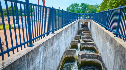 Aerial View of Concrete Fish Ladder in Park with Blue Railings photo