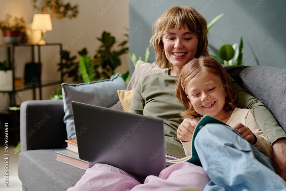 Little girl smiling and demonstrating new sketches to her mom who working remotely Little girl smiling and demonstrating new sketches to her mom who working remotely