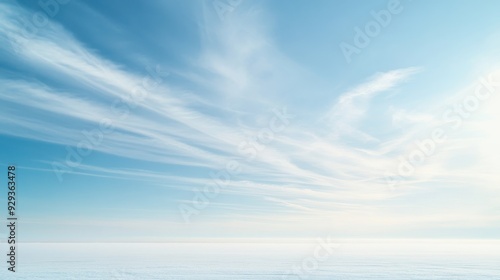 A serene sky with wispy clouds over a calm horizon.