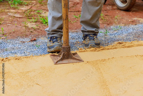 Sand tamping with worker uses manual rammer