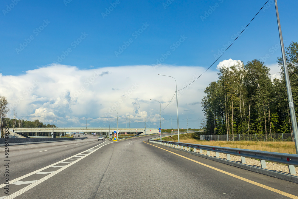 A highway with a bridge in the background A highway with a bridge in the background