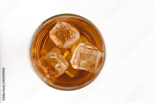 A glass of whisky with ice cubes (top view)