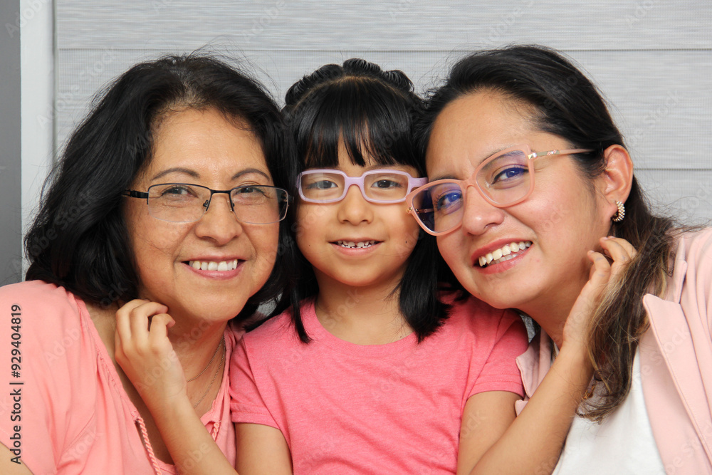 Three Generations of women Grandmother, mom and brunette Latina daughter with glasses show their love and celebrate Mother's Day Three Generations of women Grandmother, mom and brunette Latina daughter with glasses show their love and celebrate Mother's Day