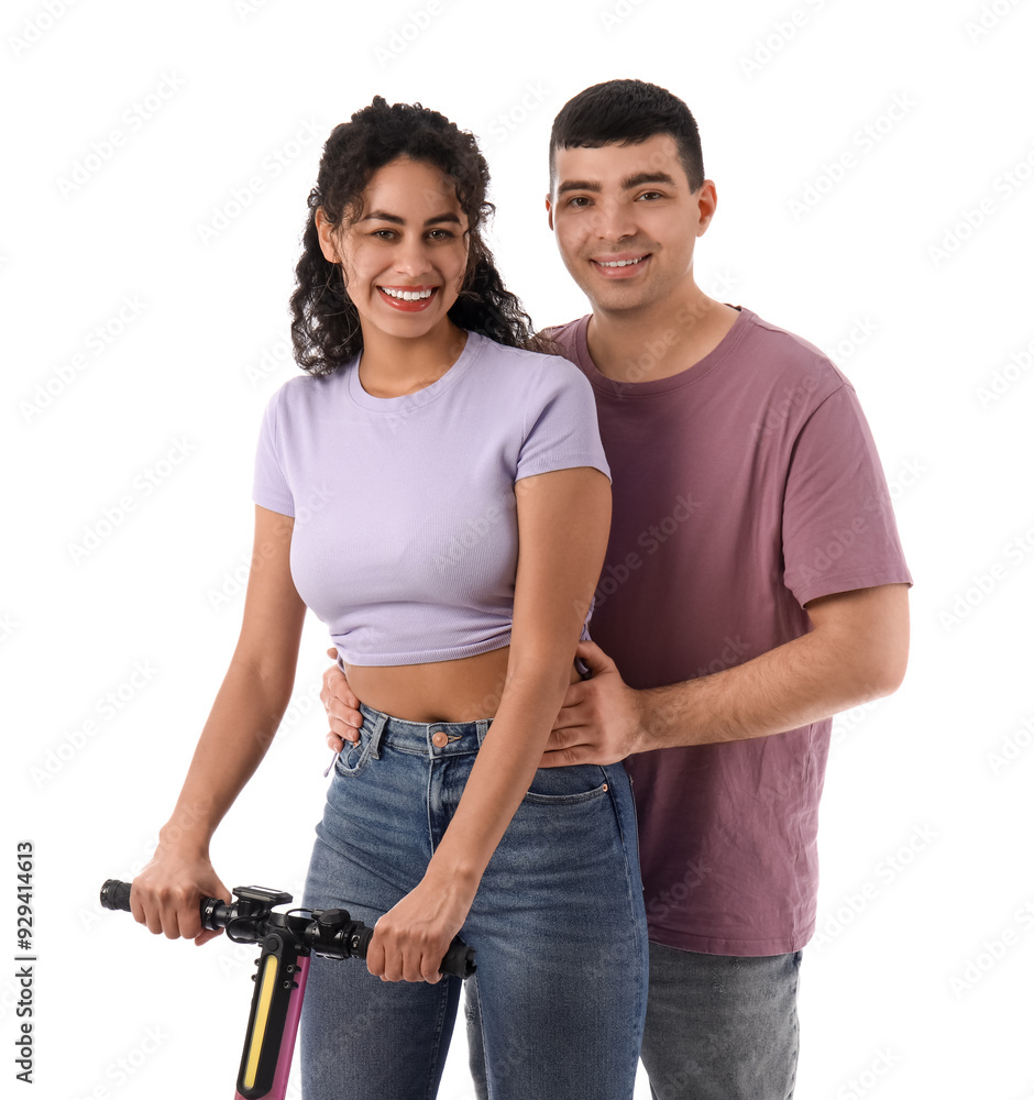 Fototapeta premium Beautiful young couple with modern electric kick scooter on white background