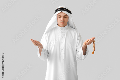 Young Muslim man praying wi...