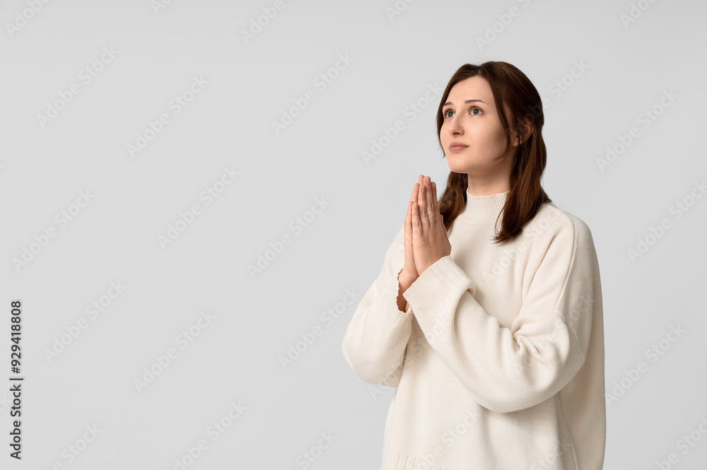 Religious young woman praying on white background Religious young woman praying on white background