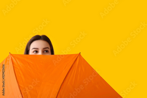 Young woman with opened umb...