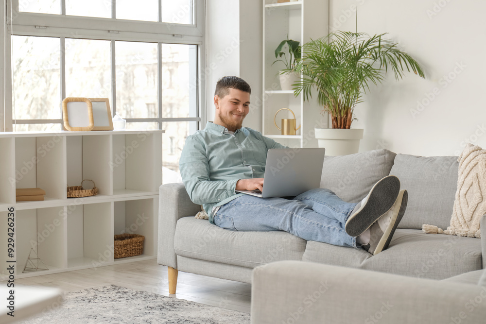 Young bearded man using laptop at home Young bearded man using laptop at home