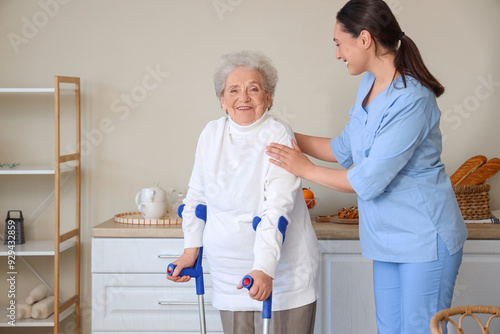 Elderly woman with crutches...