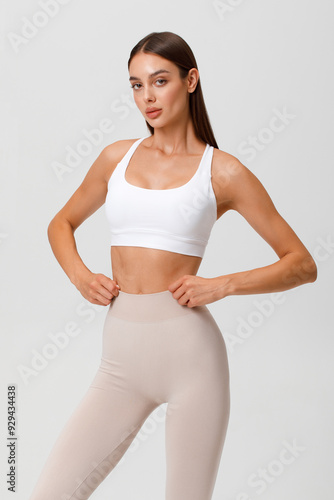 Fitness woman. Athletic girl on the gray background