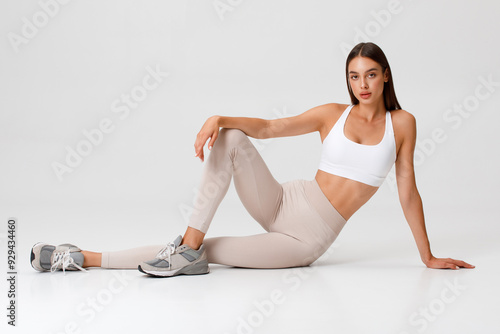 Fitness woman. Athletic girl on the gray background photo