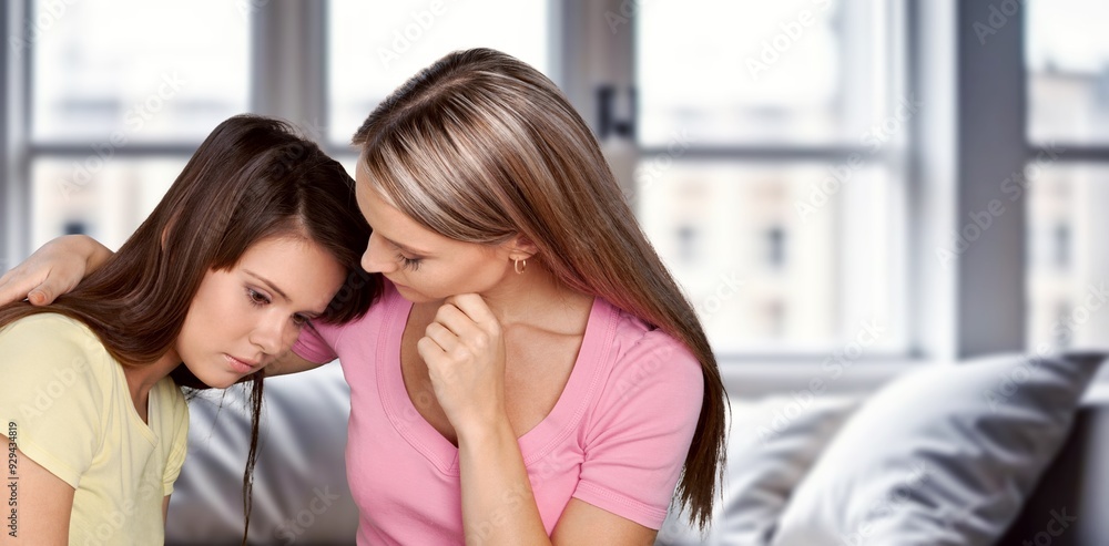 Young woman supporting her friend at home. Young woman supporting her friend at home.