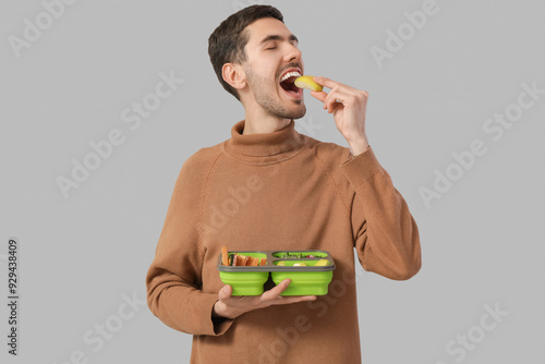 Young man with lunchbox on ...